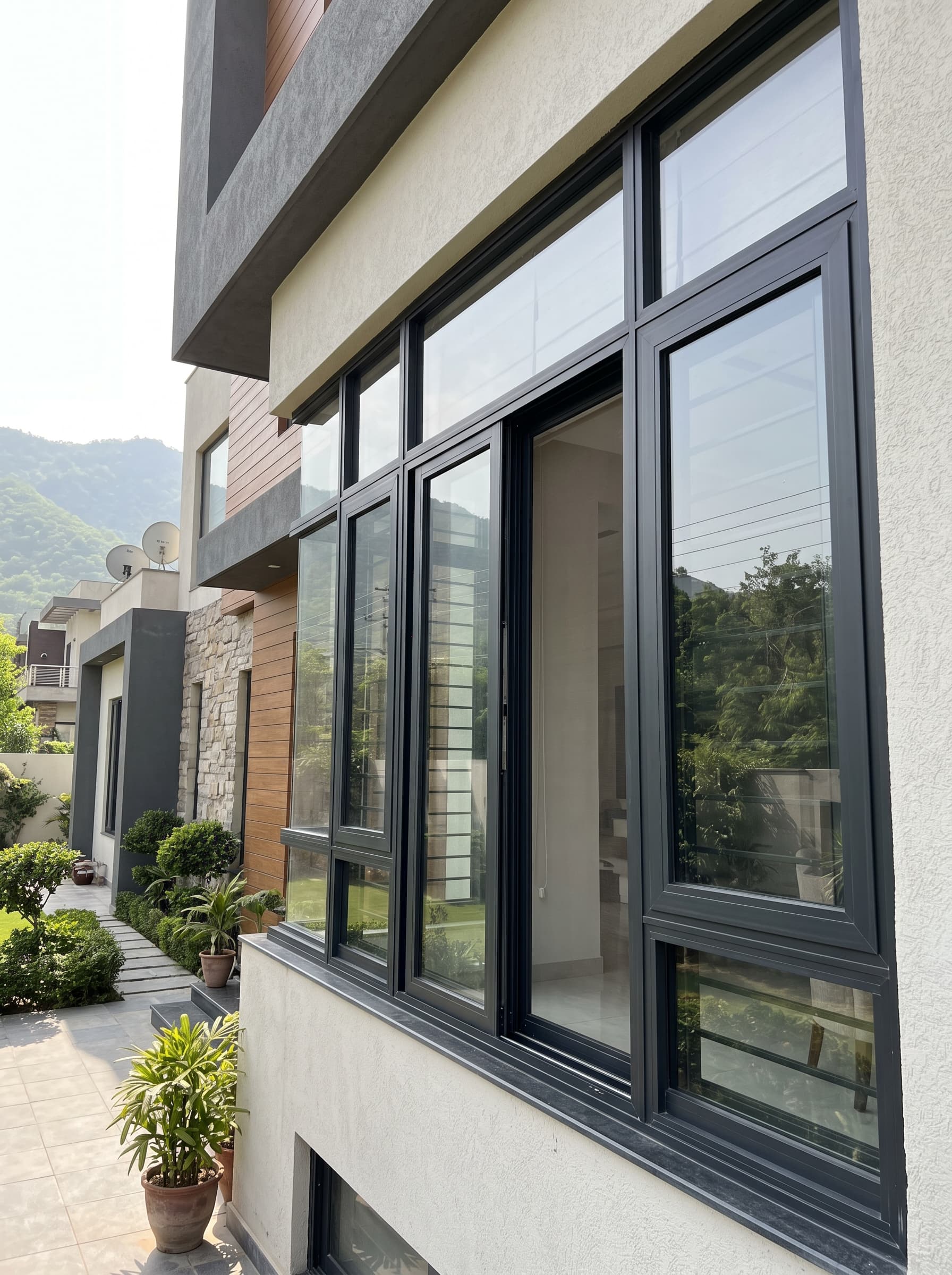 Black aluminium-framed windows on the corner of a modern house