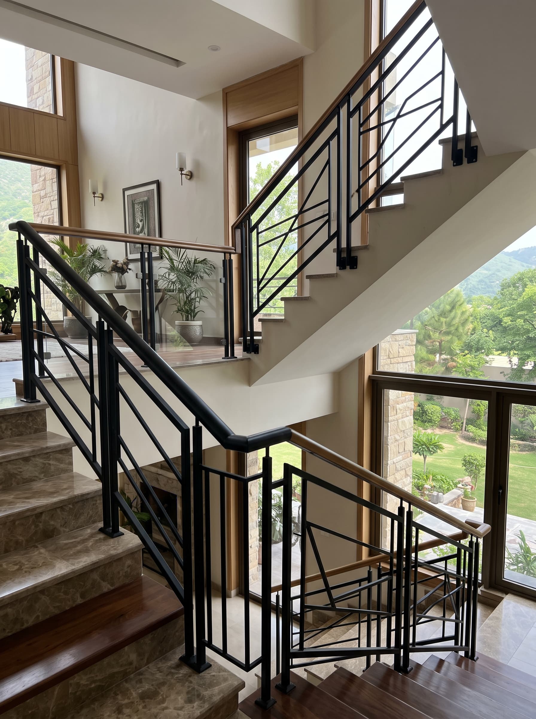 Black steel stair railing with geometric balusters in a bright stairwell